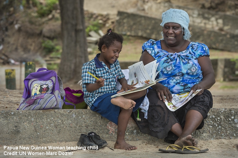 Papua New Guinea Woman teaching child